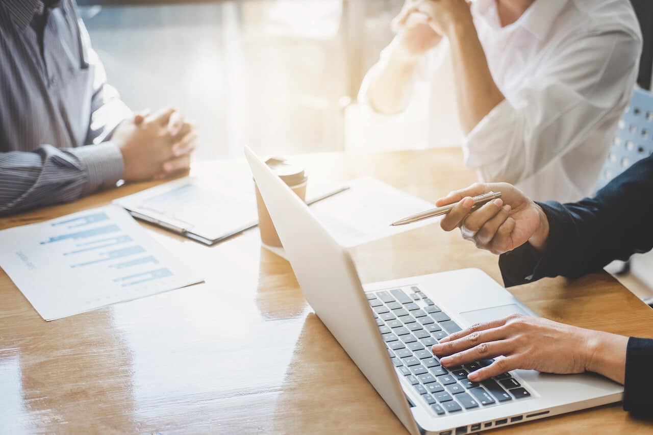 Crested Butte real estate - image of three people sitting at table with a laptop.