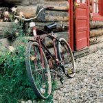 Townie Bike leaned up against a historic cabin. Events in Crested Butte